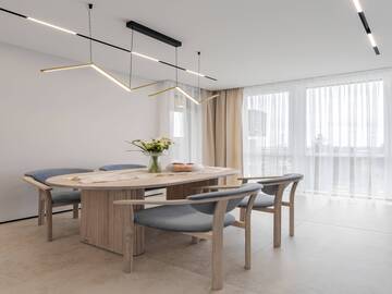 Вітальня з м’якими меблями та сучасним освітленням після ремонту в новобудові